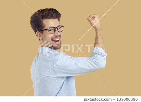 Happy person demonstrates his victory with a raised fist up. Happy person demonstrates his victory with a raised fist up. 135006380