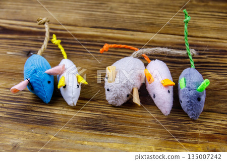 Set of mouses toys for cat on wooden background Set of mouses toys for cat on wooden background 135007242