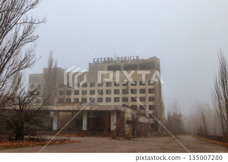 Abandoned building of Polissya hotel in the ghost town Pripyat in Chernobyl Exclusion Zone, Ukraine. Inscription in Ukrainian: Hotel Polissya Abandoned building of Polissya hotel in the ghost town Pripyat in Chernobyl Exclusion Zone, Ukraine. Inscription in Ukrainian: Hotel Polissya 135007280