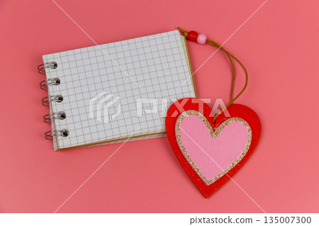 Heart and blank notepad on pastel pink background. Top view, flat lay. Valentine Day concept 135007300