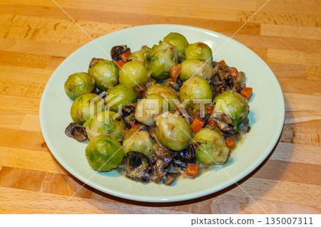 Brussels sprouts roasted with mushrooms and carrot on wooden table Brussels sprouts roasted with mushrooms and carrot on wooden table 135007311