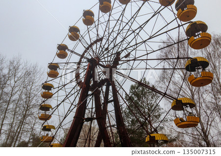 Abandoned Ferris Wheel in the amusement park of ghost town Pripyat in Chernobyl Exclusion Zone, Ukraine 135007315