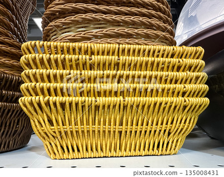 Stacked wicker baskets in a store display. Stacked wicker baskets in a store display. 135008431