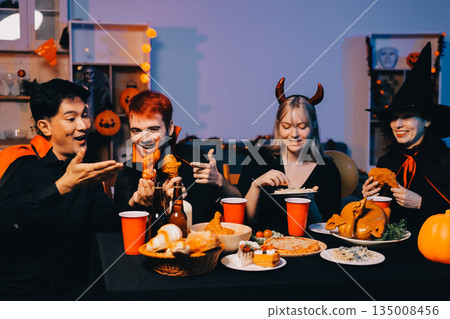 Friends enjoying a Halloween party at a bar making a toast Friends enjoying a Halloween party at a bar making a toast 135008456