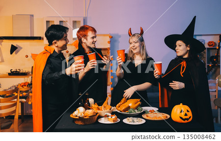 Friends enjoying a Halloween party at a bar making a toast Friends enjoying a Halloween party at a bar making a toast 135008462