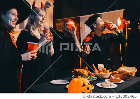 Friends enjoying a Halloween party at a bar making a toast Friends enjoying a Halloween party at a bar making a toast 135008466