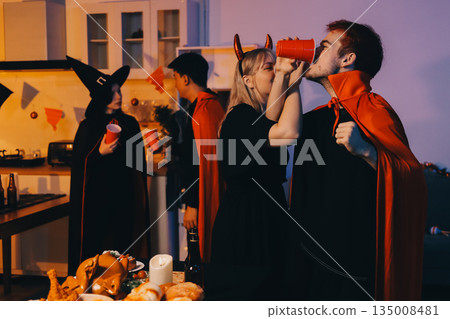 Friends enjoying a Halloween party at a bar making a toast 135008481