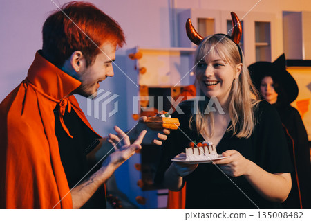 Friends enjoying a Halloween party at a bar making a toast 135008482