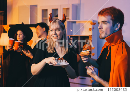 Friends enjoying a Halloween party at a bar making a toast 135008483