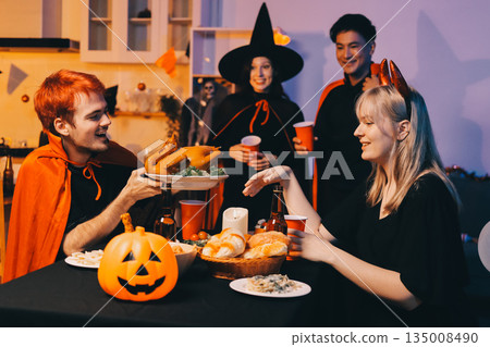 Friends enjoying a Halloween party at a bar making a toast 135008490