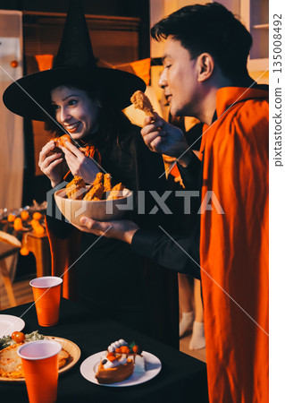 Friends enjoying a Halloween party at a bar making a toast Friends enjoying a Halloween party at a bar making a toast 135008492