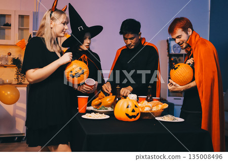 Friends enjoying a Halloween party at a bar making a toast Friends enjoying a Halloween party at a bar making a toast 135008496