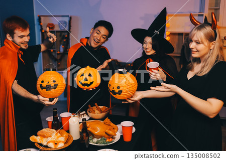 Friends enjoying a Halloween party at a bar making a toast 135008502