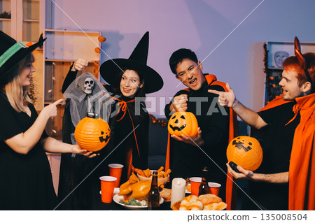 Friends enjoying a Halloween party at a bar making a toast Friends enjoying a Halloween party at a bar making a toast 135008504