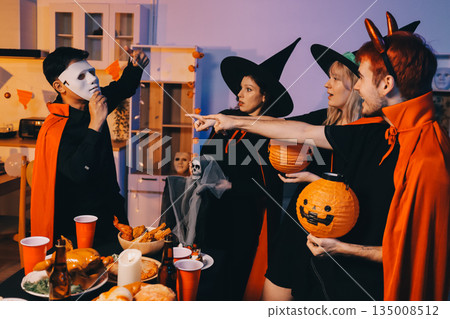 Friends enjoying a Halloween party at a bar making a toast Friends enjoying a Halloween party at a bar making a toast 135008512