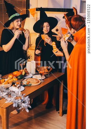 Friends enjoying a Halloween party at a bar making a toast Friends enjoying a Halloween party at a bar making a toast 135008522