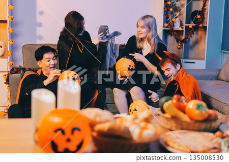 Friends enjoying a Halloween party at a bar making a toast Friends enjoying a Halloween party at a bar making a toast 135008530