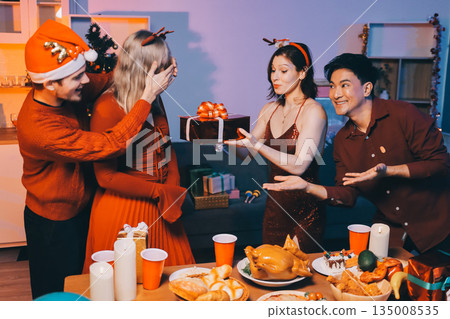 Festive Office Christmas Party with Delicious Food. A beautifully decorated office space with Christmas trees and festive lights, set up for a holiday party. 135008535