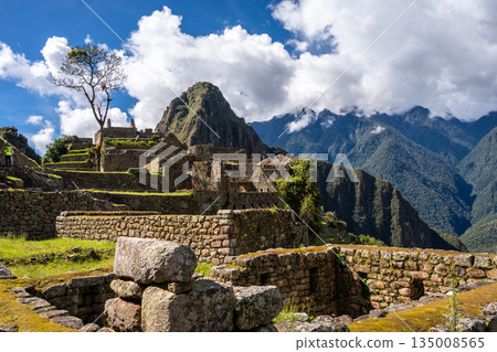 Panoramic view of Machu Picchu ruins with Huayna Picchu in background, Peru Panoramic view of Machu Picchu ruins with Huayna Picchu in background, Peru 135008565
