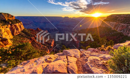A scenic sunset and sunrise over the grand canyon in Arizona's national park reveal a majestic landscape of desert rocks, mountain clouds, and the vast scenic valley view A scenic sunset and sunrise over the grand canyon in Arizona's national park reveal a majestic landscape of desert rocks, mountain clouds, and the vast scenic valley view 135009221