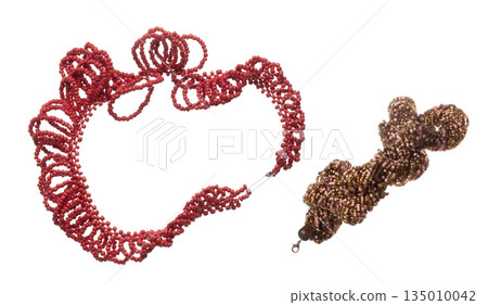 Colorful Tribal bead style necklet fly in air. Red color bead necklace as gemstone for fashion ornament decorative items. Fashion ornament necklace to add more style. White background isolated Colorful Tribal bead style necklet fly in air. Red color bead necklace as gemstone for fashion ornament decorative items. Fashion ornament necklace to add more style. White background isolated 135010042