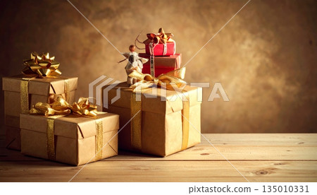A red Christmas gift box with a silk ribbon bow sits beside burning wax candles to create a warm holiday candlelight celebration during the December season A red Christmas gift box with a silk ribbon bow sits beside burning wax candles to create a warm holiday candlelight celebration during the December season 135010331