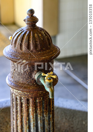 closeup of old style brass water tap installed in public rest room. closeup of old style brass water tap installed in public rest room. 135010358