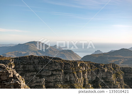 Mountain landscape with a view of the ocean. Scenic natural background Mountain landscape with a view of the ocean. Scenic natural background 135010421