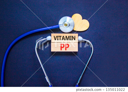 Vitamin PP symbol. Concept words Vitamin PP on beautiful wooden blocks. Wooden heart and stethoscope. Beautiful black background. Medical healthy lifestyle Vitamin PP concept. Vitamin PP symbol. Concept words Vitamin PP on beautiful wooden blocks. Wooden heart and stethoscope. Beautiful black background. Medical healthy lifestyle Vitamin PP concept. 135011022