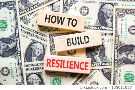 How to build resilience symbol. Concept words How to build resilience on beautiful wooden blocks. Beautiful dollar bills background. Dollar bills. Business how to build resilience concept. Copy space. How to build resilience symbol. Concept words How to build resilience on beautiful wooden blocks. Beautiful dollar bills background. Dollar bills. Business how to build resilience concept. Copy space. 135011037