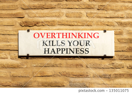 Overthinking kills your happiness symbol. Concept words Overthinking kills your happiness on sign plate. Beautiful brick wall background. Business overthinking kills happiness concept. Copy space. Overthinking kills your happiness symbol. Concept words Overthinking kills your happiness on sign plate. Beautiful brick wall background. Business overthinking kills happiness concept. Copy space. 135011075