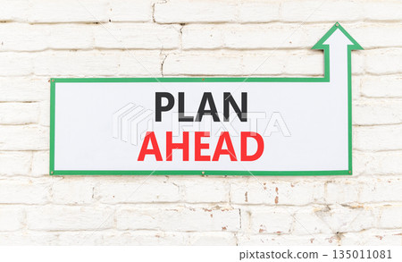Plan ahead symbol. Concept word Plan ahead on beautiful white sign on white brick wall. Beautiful white brick wall background. Business plan ahead concept. Copy space. 135011081