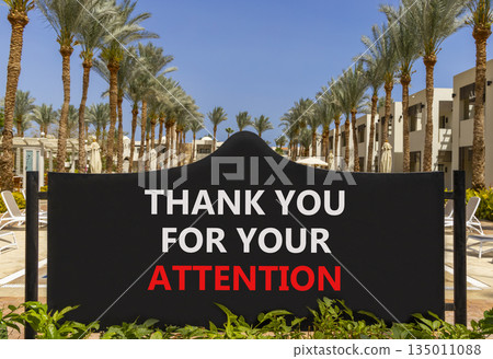 Thank you for your attention symbol. Concept words Thank you for your attention on black road sign. Beautiful palm trees blue sky background. Business thank you for your attention concept. Copy space. 135011088