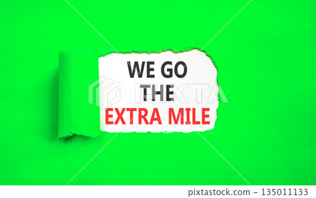 Support, help we go the extra mile symbol. Concept words We go the extra mile on beautiful white paper. Beautiful green paper background. Business we go the extra mile concept. Copy space. 135011133