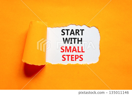 Start with small steps symbol. Concept words phrase Start with small steps on beautiful white paper. Beautiful orange paper background. Business Start with small steps concept. Copy space. 135011146