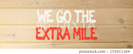 Support, help we go the extra mile symbol. Concept words We go the extra mile on beautiful wooden wall. Beautiful wooden wall background. Business we go the extra mile concept. Copy space. Support, help we go the extra mile symbol. Concept words We go the extra mile on beautiful wooden wall. Beautiful wooden wall background. Business we go the extra mile concept. Copy space. 135011164