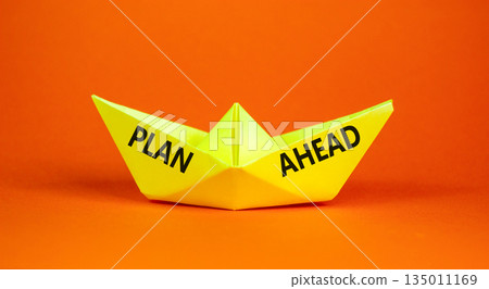 Plan ahead symbol. Concept word Plan ahead on beautiful yellow paper boat. Beautiful orange paper background. Business plan ahead concept. Copy space. 135011169