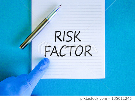 Risk factor symbol. Concept words Risk factor on beautiful white note. Doctor's hand in blue medical glove. Black pen. Beautiful blue background. Medical healthy lifestyle risk factor concept. Risk factor symbol. Concept words Risk factor on beautiful white note. Doctor's hand in blue medical glove. Black pen. Beautiful blue background. Medical healthy lifestyle risk factor concept. 135011245