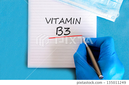 Vitamin B3 niacin symbol. Concept words Vitamin B3 on beautiful white note. Doctor's hand in blue medical glove. Beautiful blue background. Medical healthy lifestyle Vitamin B3 niacin concept. Vitamin B3 niacin symbol. Concept words Vitamin B3 on beautiful white note. Doctor's hand in blue medical glove. Beautiful blue background. Medical healthy lifestyle Vitamin B3 niacin concept. 135011249