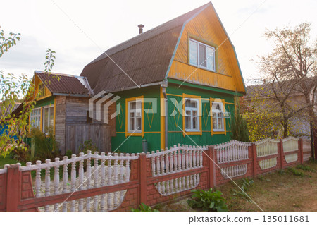 A small wooden country house on a summer street. A small wooden country house on a summer street. 135011681