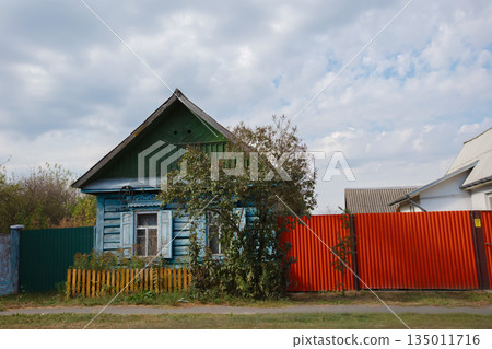One-story Russian village house with carved shutters. One-story Russian village house with carved shutters. 135011716