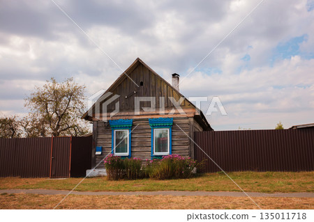 One-story Russian village house with carved shutters. One-story Russian village house with carved shutters. 135011718