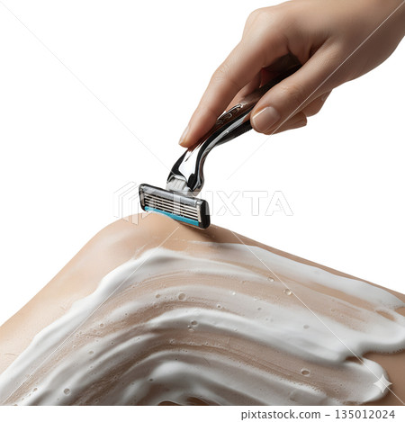 Woman's hand shaving a lathered leg with a modern razor, representing daily personal hygiene, grooming, and hair removal routines 135012024