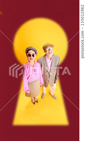 Conceptual poster of senior couple inside keyhole background. Conceptual poster of senior couple inside keyhole background. 135012862