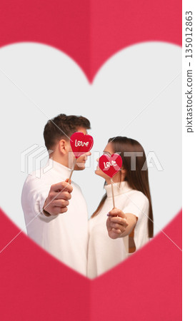 Clean poster of couple holding heart props inside heart frame. 135012863
