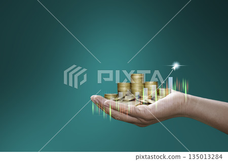 Hand holding stacked coins with rising chart and glowing arrow, representing financial growth, investment success, and economic prosperity. Hand holding stacked coins with rising chart and glowing arrow, representing financial growth, investment success, and economic prosperity. 135013284