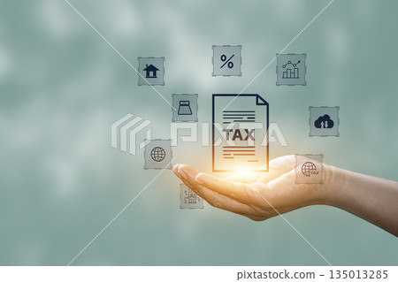 Tax increase concept. tax icon in hand. increasing taxes, Pay online income tax. income tax system icon around. futuristic virtual screen interface technology. 135013285