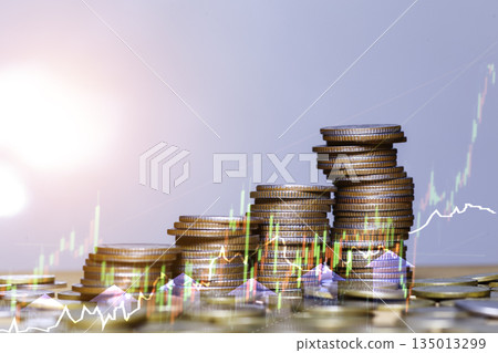 Investment Growth Concept with Stacked Coins and Rising Graph. Stacked coins with upward green arrow and financial graph showing investment growth, profit increase, and financial success concept. 135013299