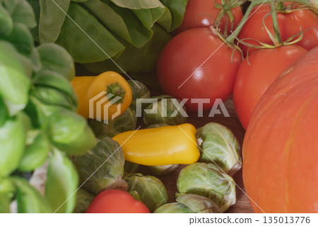Fresh basil, colorful peppers, pumpkin, and brussel sprouts for healthy cooking 135013776