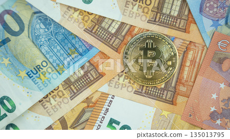 Bitcoin coin on euro banknotes background. 135013795
